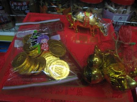 gold chocolate coins, the carabao, and other items (carp, pineapple, round objects)